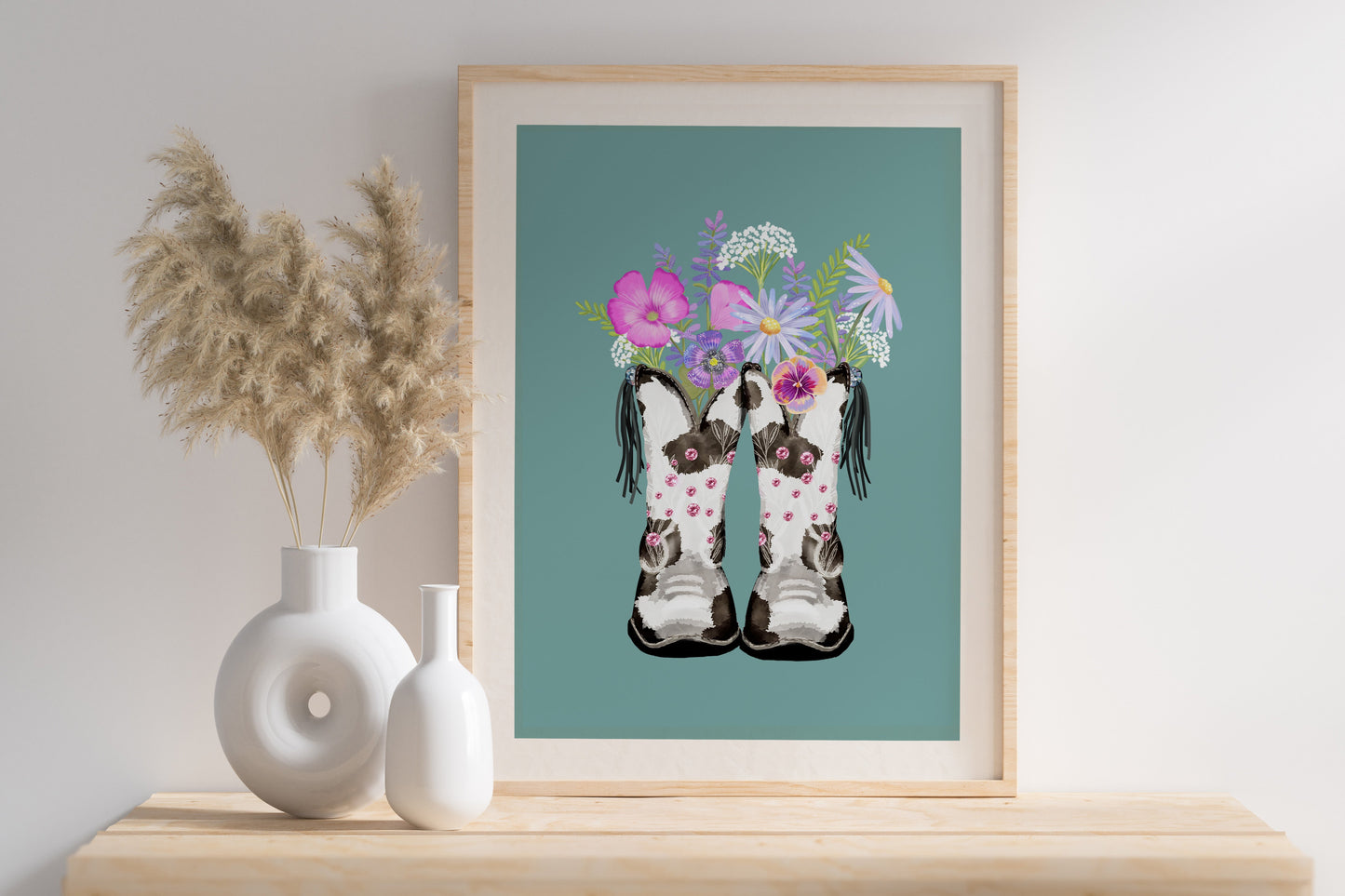 cowboy boots being used as a floral vase, with beautiful hand painted flowers on a teal background