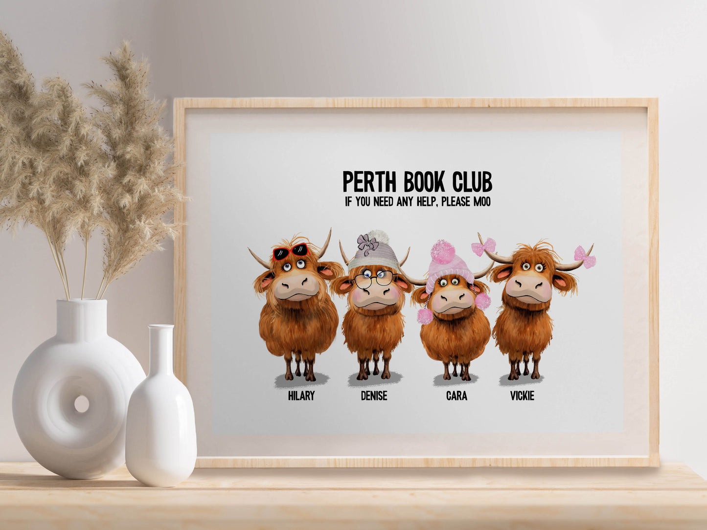 personalised artwork with cartoon Highland cows and text on a light background with individual names