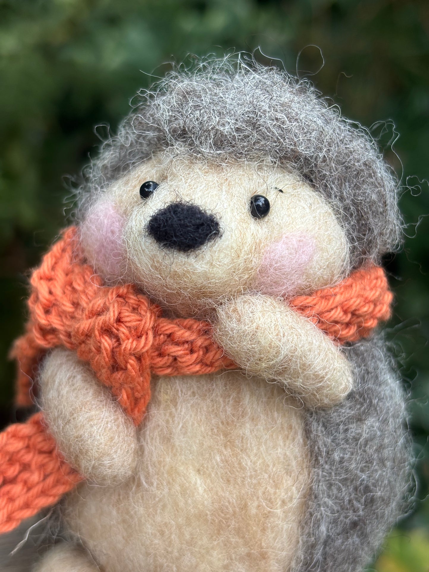 needle felted hedgehog with character face and orange scarf